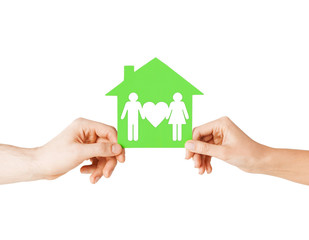 Fototapeta na wymiar hands holding green house with family