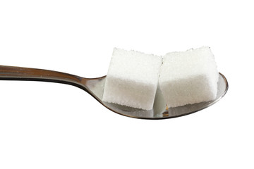 Würfelzucker auf Löffel