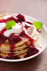 pancakes with cherry jam and cream for breakfast