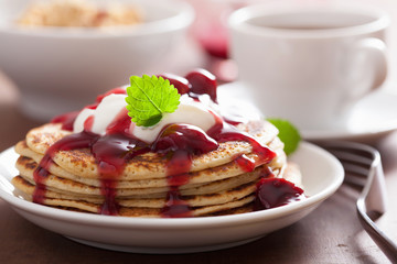 pancakes with cherry jam and cream for breakfast