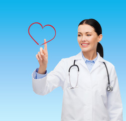 smiling female doctor pointing to heart