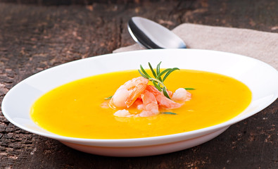 Pumpkin soup with shrimp and rosemary