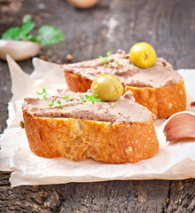Homemade meat snack chicken liver pate with savory and olives
