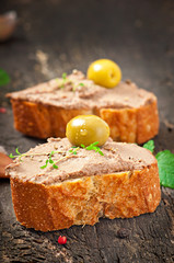 Homemade meat snack chicken liver pate with savory and olives