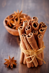 Cinnamon sticks and star anise on a wooden background