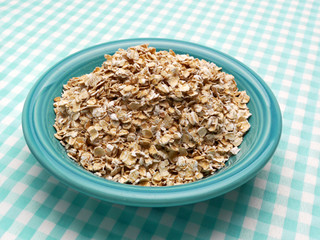Uncooked oatmeal in a blue bowl