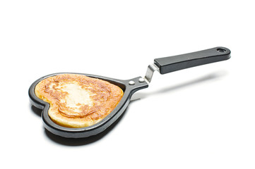 Pastry in the heart shape pan isolated