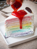 strawberry sauce on rainbow crape cake