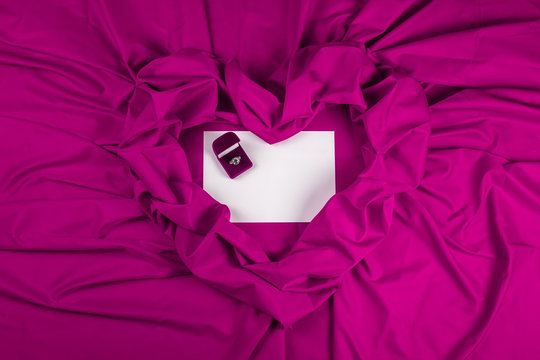 love card with diamond ring on a purple fabric