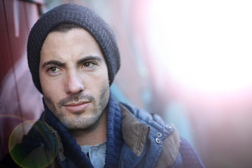 Portrait of trendy guy in abandoned place