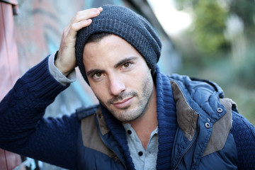 Portrait of trendy guy in abandoned place