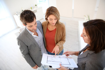 Couple meeting architect for house construction