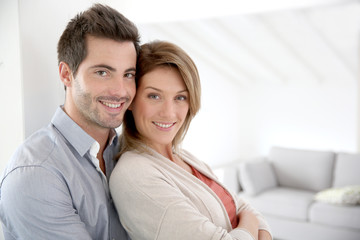 Couple standing in contemporary home