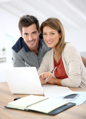 Couple at home working on laptop computer