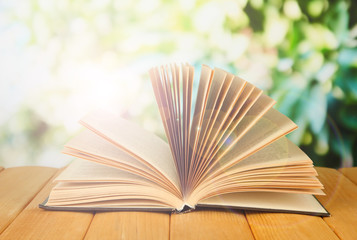 Opened book on bright background