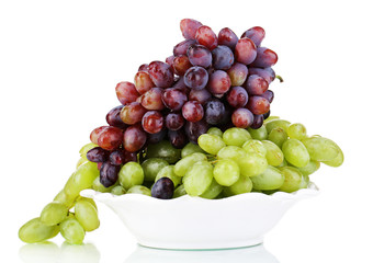 Ripe green and purple grapes on plate isolated on white