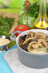 Fried chicken livers in pan on wooden table close-up