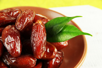 Dried dates on plate on table close up