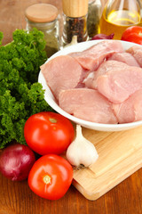 Raw turkey meat on wooden table close up