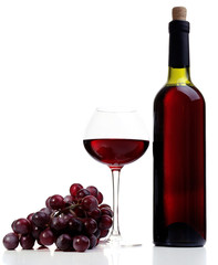 Wineglass with red wine, grape and bottle isolated on white