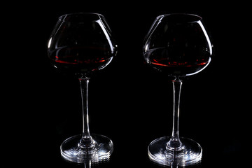Wineglasses with red wine, isolated on black