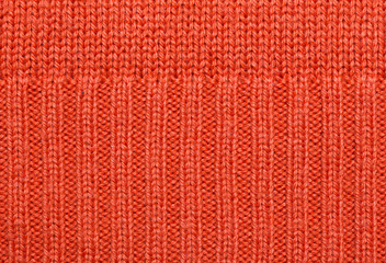Red knitted fabric texture. Abstract background.