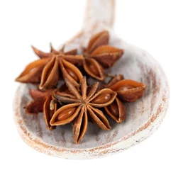 Foto auf Acrylglas Star anise in wooden spoon, isolated on white © Africa Studio
