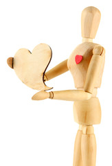 Wooden mannequin holding heart isolated on white