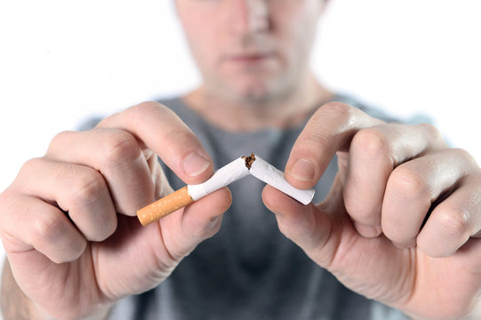 Man Breaking Cigarette Representing Quit Smoking