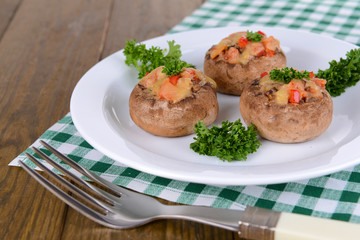 Stuffed mushrooms on plate on table close-up