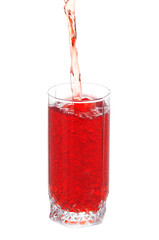 Juice pouring into glass isolated on white