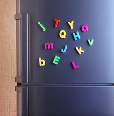 Colorful magnetic letters on  refrigerator © Africa Studio