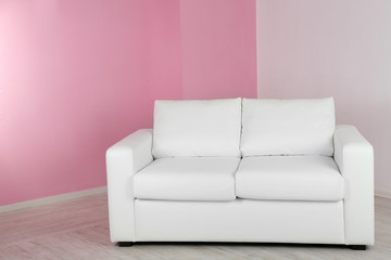 White sofa in room on pink wall background