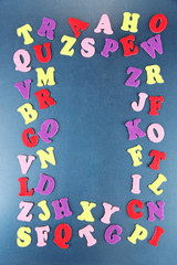 English alphabet on school desk background