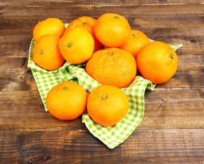 Ripe sweet tangerines on color wooden background