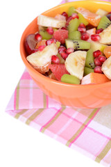 Sweet fresh fruits in bowl on table close-up