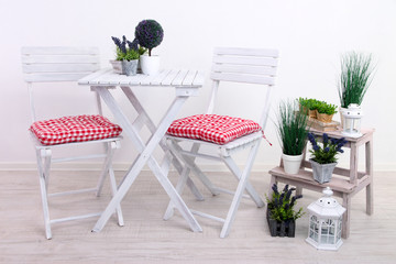 Garden chairs and table with flowers