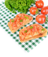 Delicious bruschetta with tomatoes on table close-up