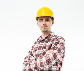 Worker in yellow helmet standing with arms crossed