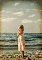 little girl on the beach. stylized old photo
