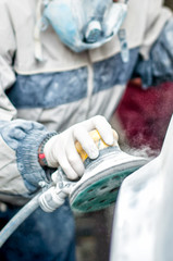 auto mechanic using the power buffer machine