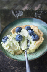 Bilberry and Goat's Cheese cream Tart on old wood