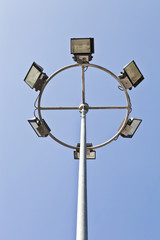 High mask spotlight light pole blue sky background