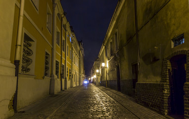 Night photo of a cobbled street in the old part of Poznan, Polan