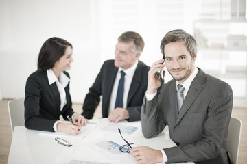 Businessman at phone in meeting