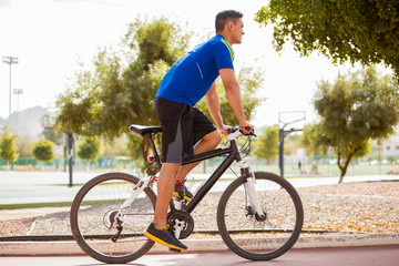 Fototapeta premium Young athlete exercising on a bike