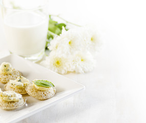 Several canapes and glass of milk