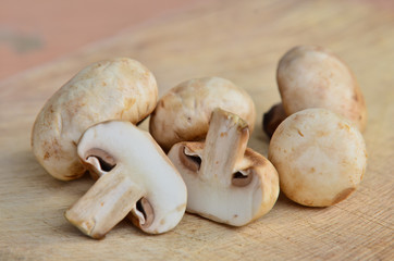 Champignon on wooden background
