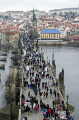 Tourists walk along the Charles Bridge