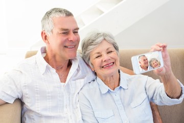 Couple taking self portrait through smart phone